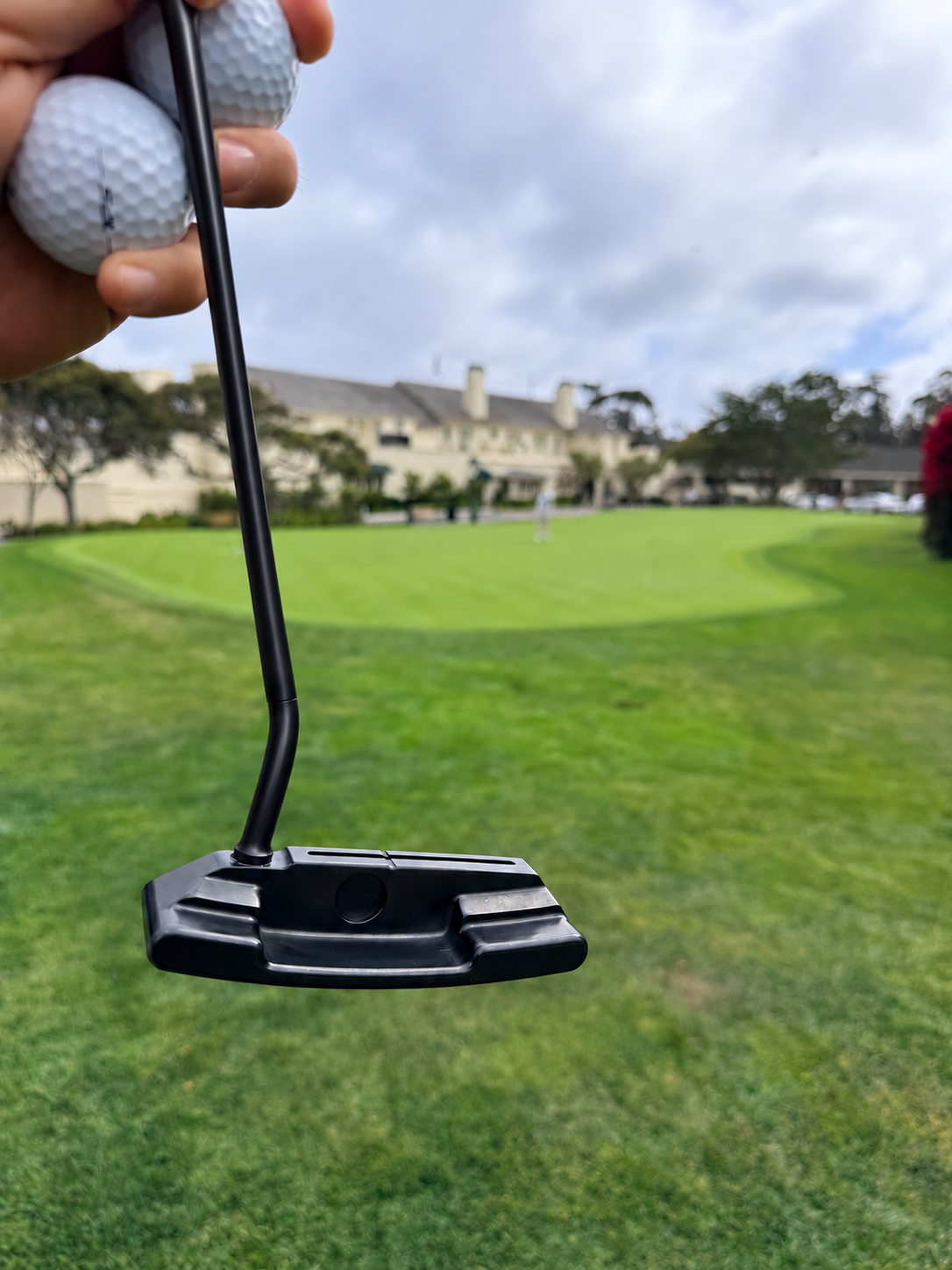 Bent putter with a black shaft on course